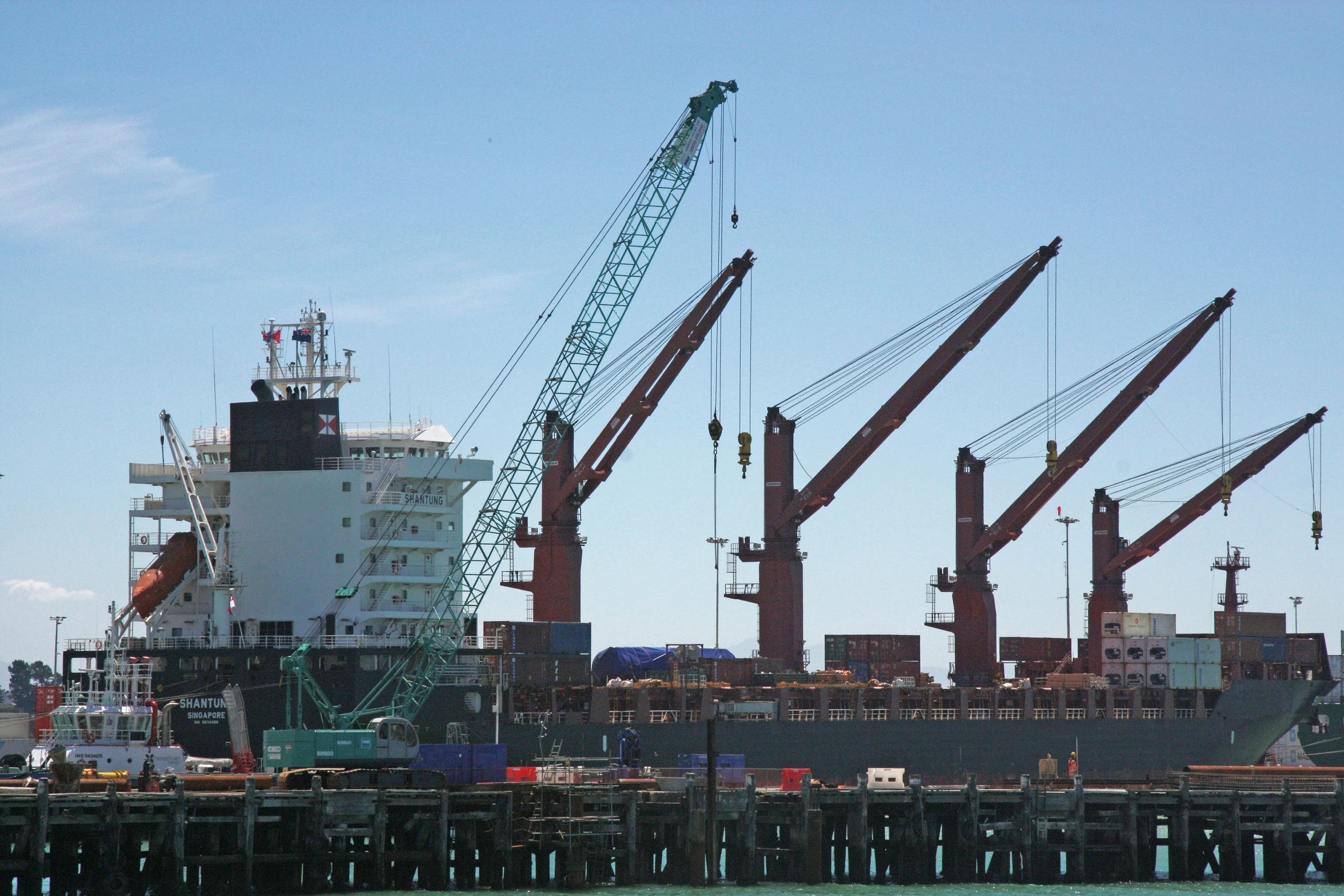 a large ship is in the ocean next to a dock