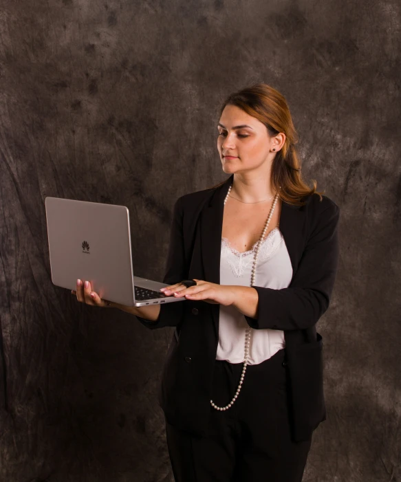 a woman that is holding a laptop computer