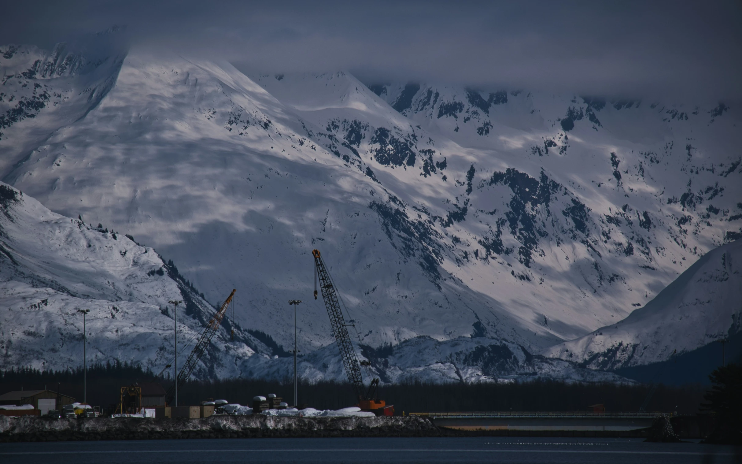 the mountains are covered with snow and crane