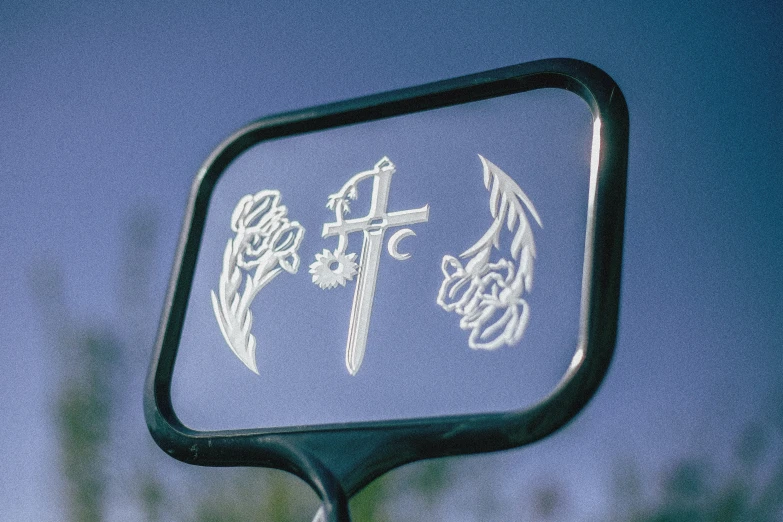 the reflection of a sign in the side mirror of a car