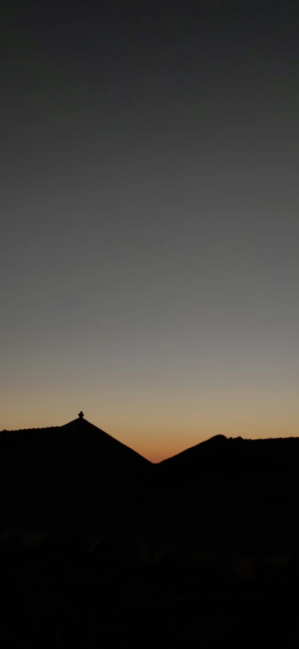 a plane is flying in the sky at sunset