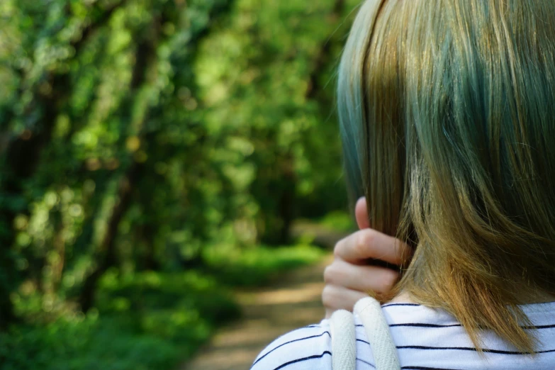 the back view of a woman with dyed blonde hair