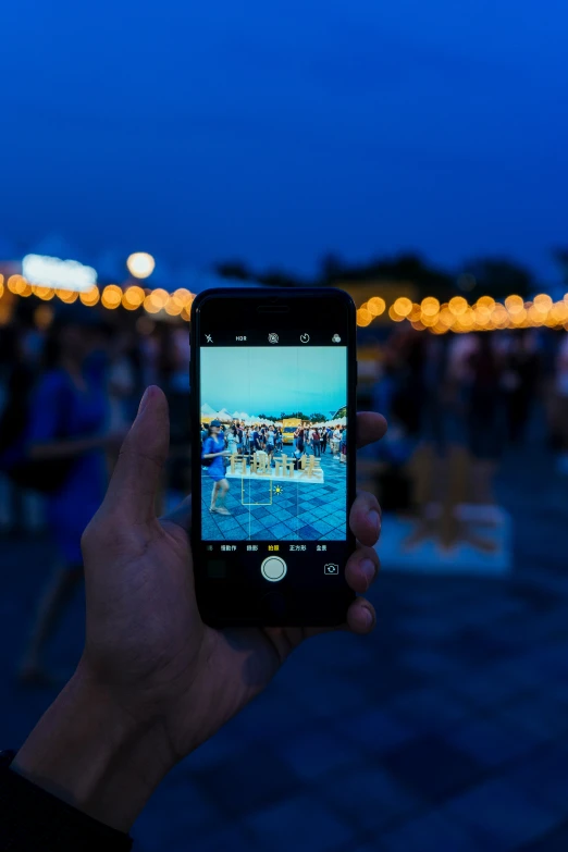 a man taking a picture of the night sky