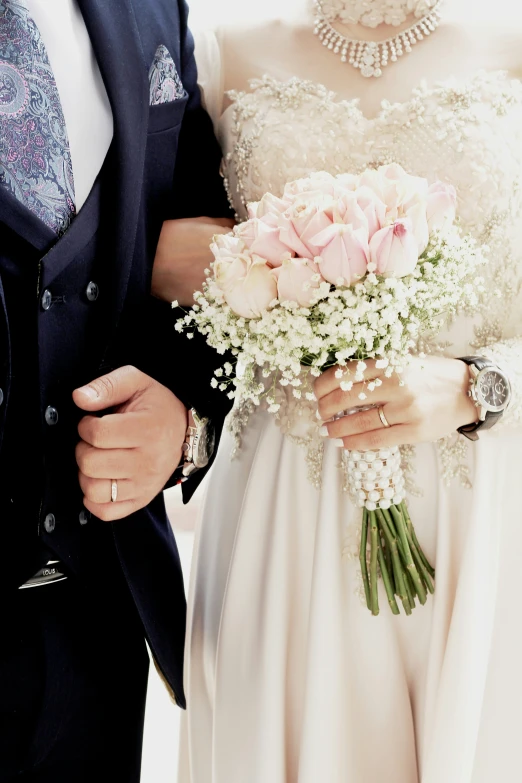 a bride and groom with wedding jewelry and rings