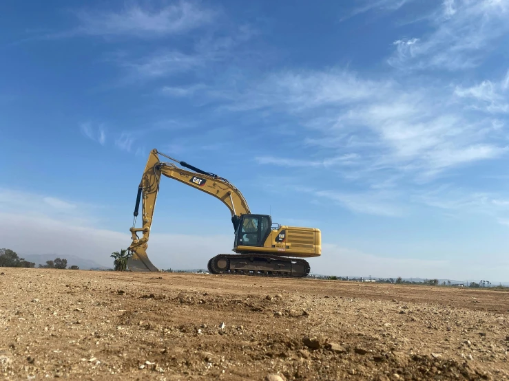 the backhoe is loaded with large machinery on the construction site