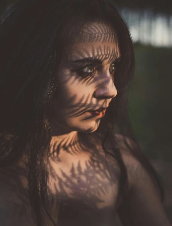 a woman with her face painted as a monster