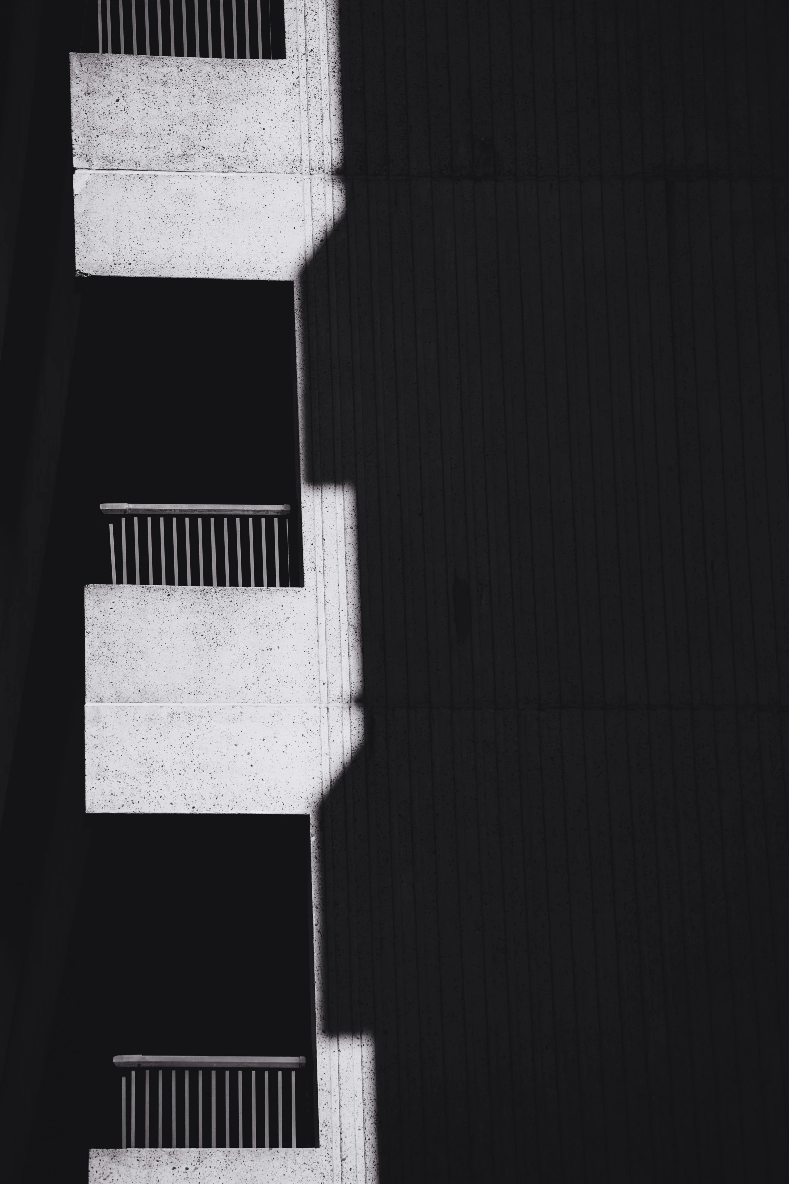 three different white stairs in between some buildings