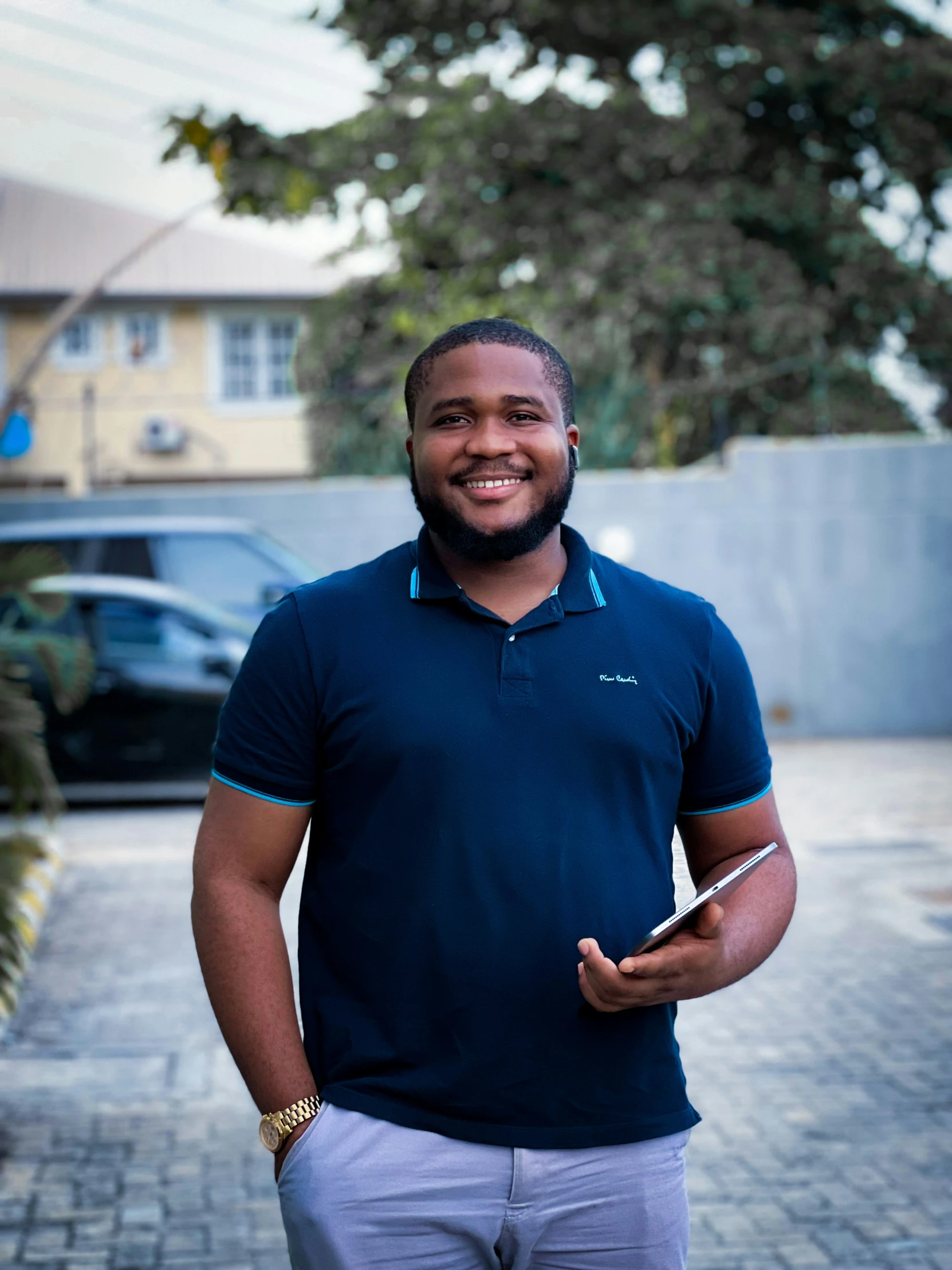 a man is standing in the street and smiling