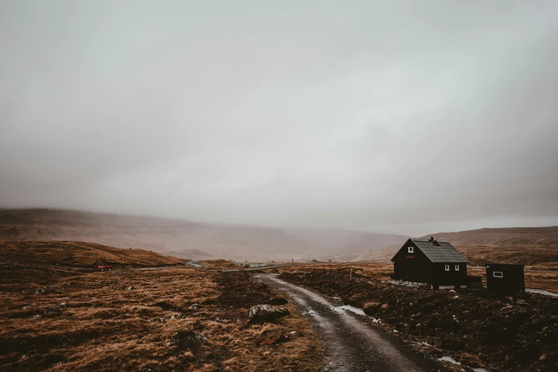 a small house is on the side of a hill