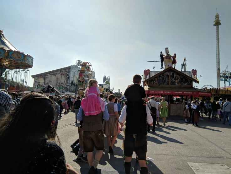 people are walking along in line at the fair