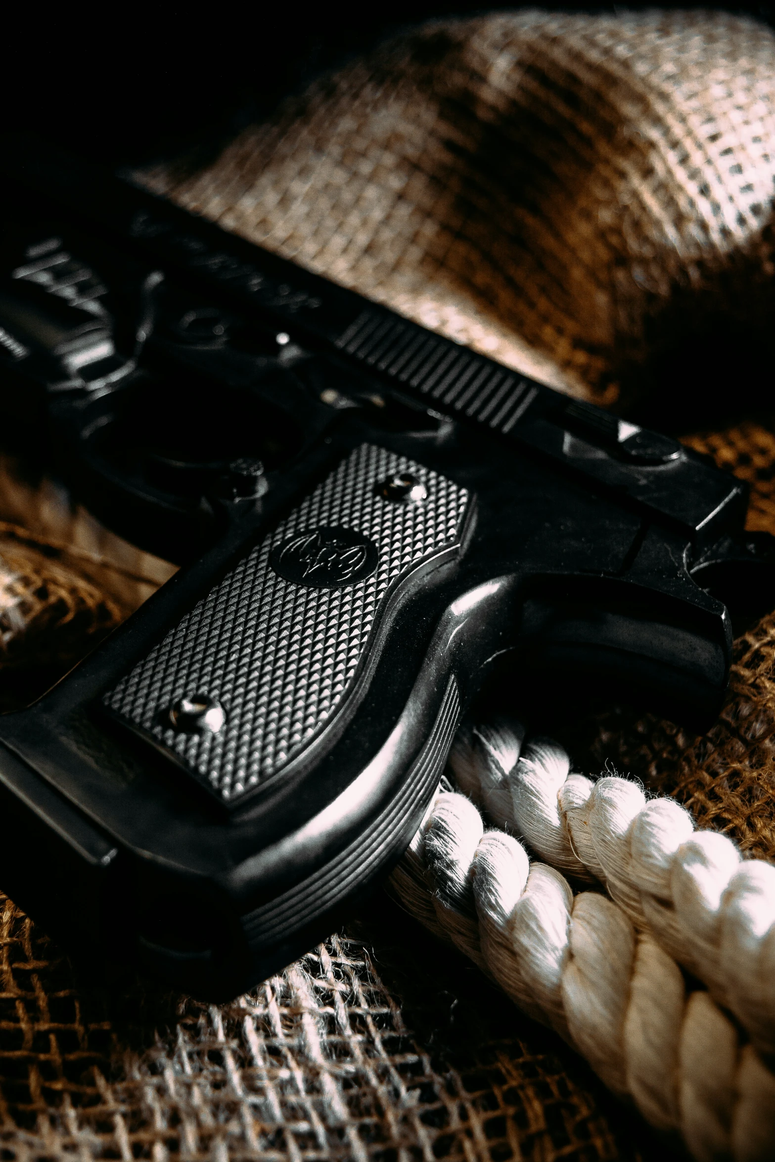 a gun lying next to an assortment of beads