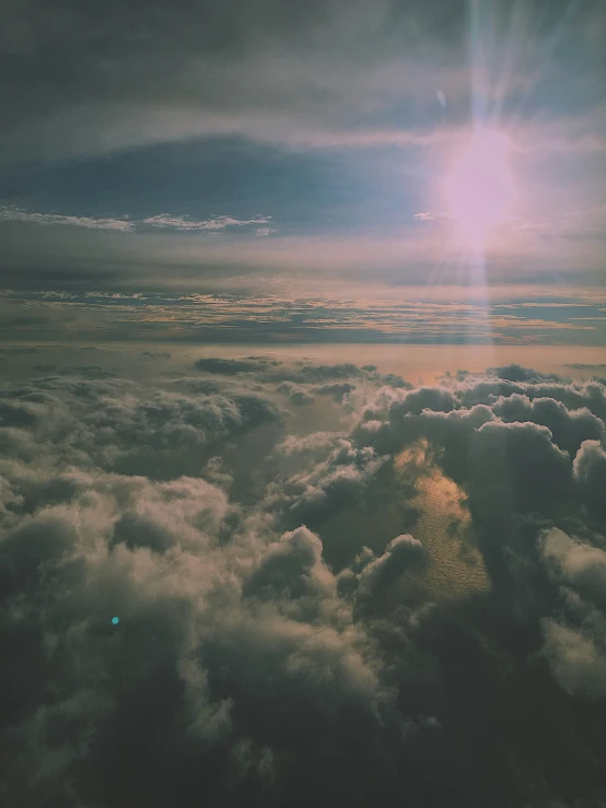 the view from an airplane of the sun and clouds