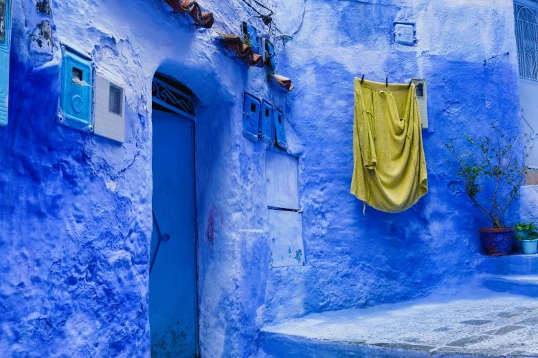 a blue alleyway with an orange blanket in the middle