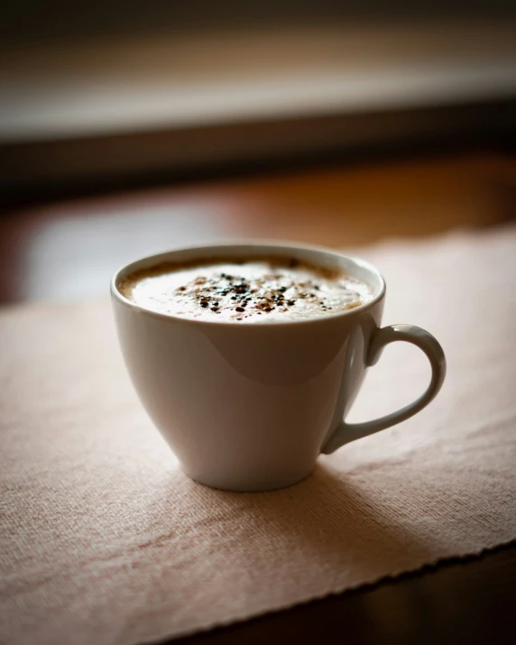 a cup of cappuccino sitting on a table