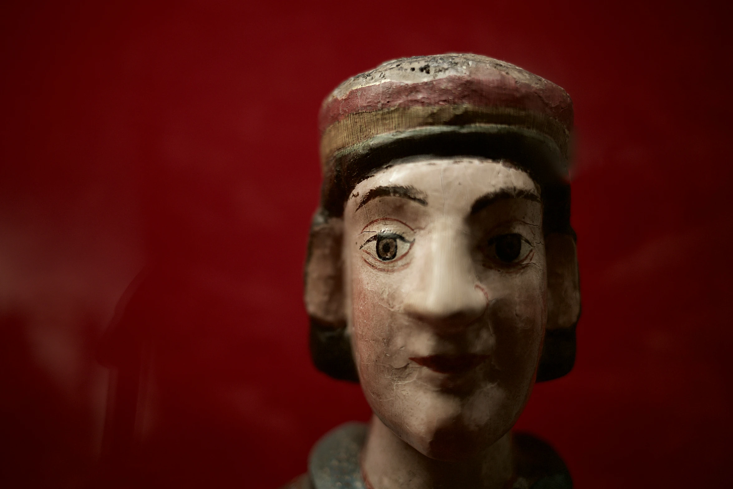 a close up of an old statue wearing a hat