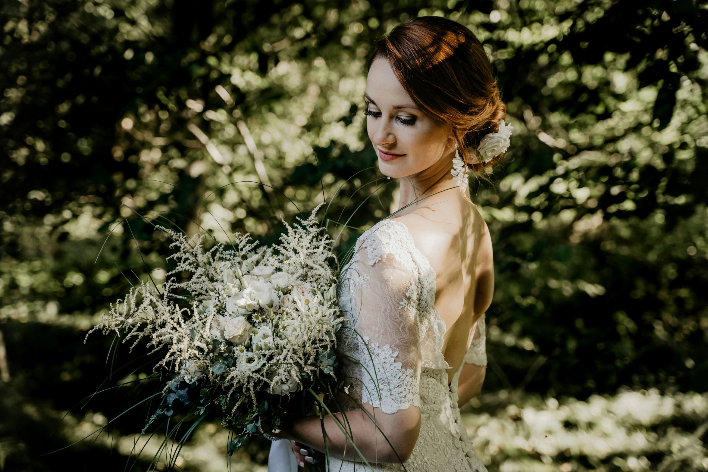 a woman wearing a dress holding a bouquet of flowers