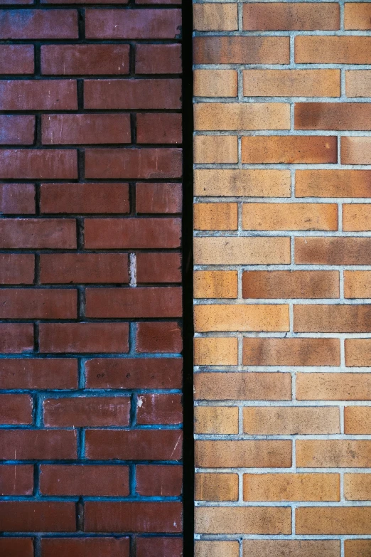 two different colored bricks on the side of a wall