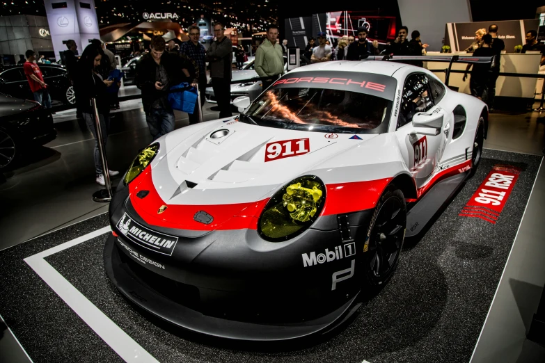 a car sitting on display at an indoor show