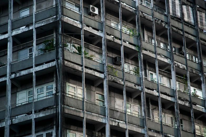 a very tall building with lots of balconies and planters growing on it