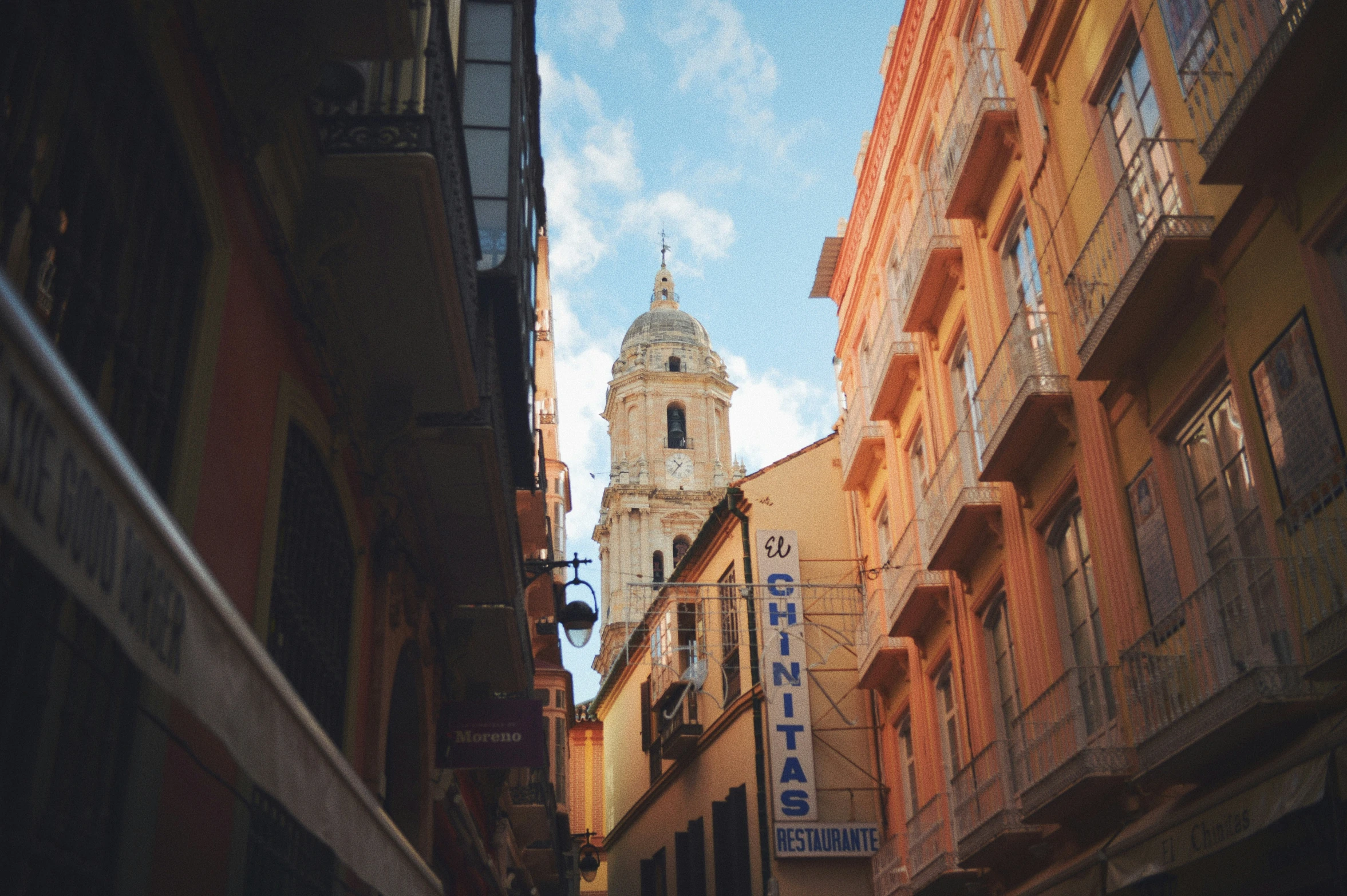 there is a large tower at the end of an alley