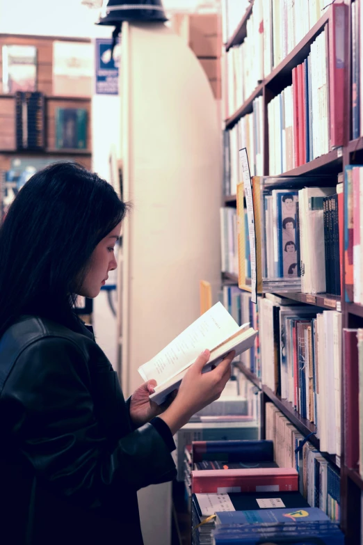 a woman reading a book in a liry