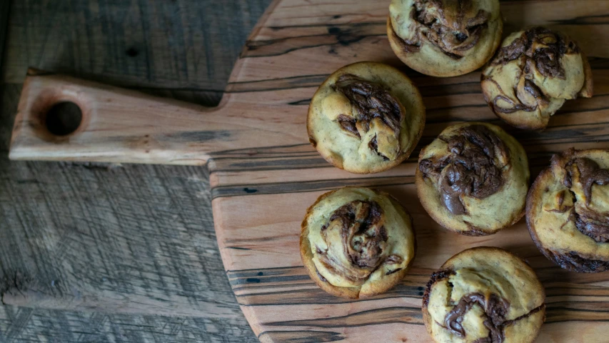 a group of cookies sitting on top of a wooden  board