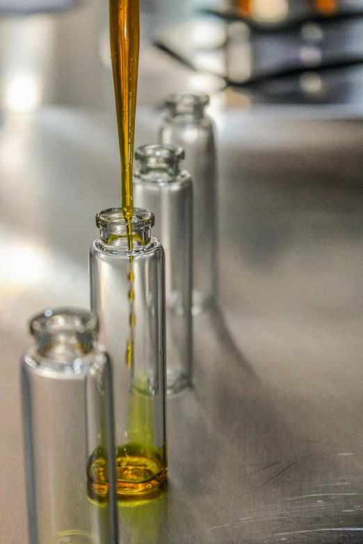 some yellow liquid is pouring into glass tubes