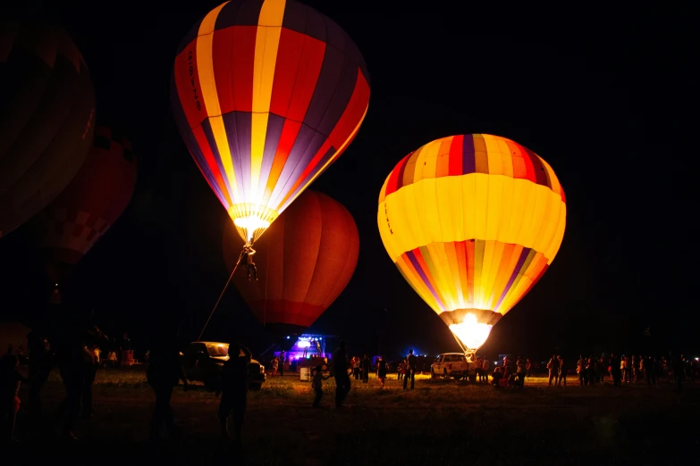 a night scene with  air balloons being taken