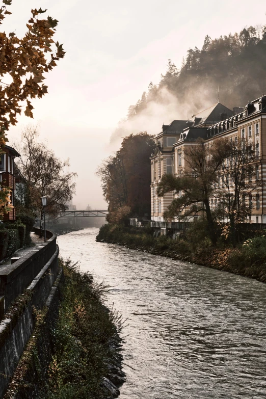 buildings are beside a river on a cloudy day