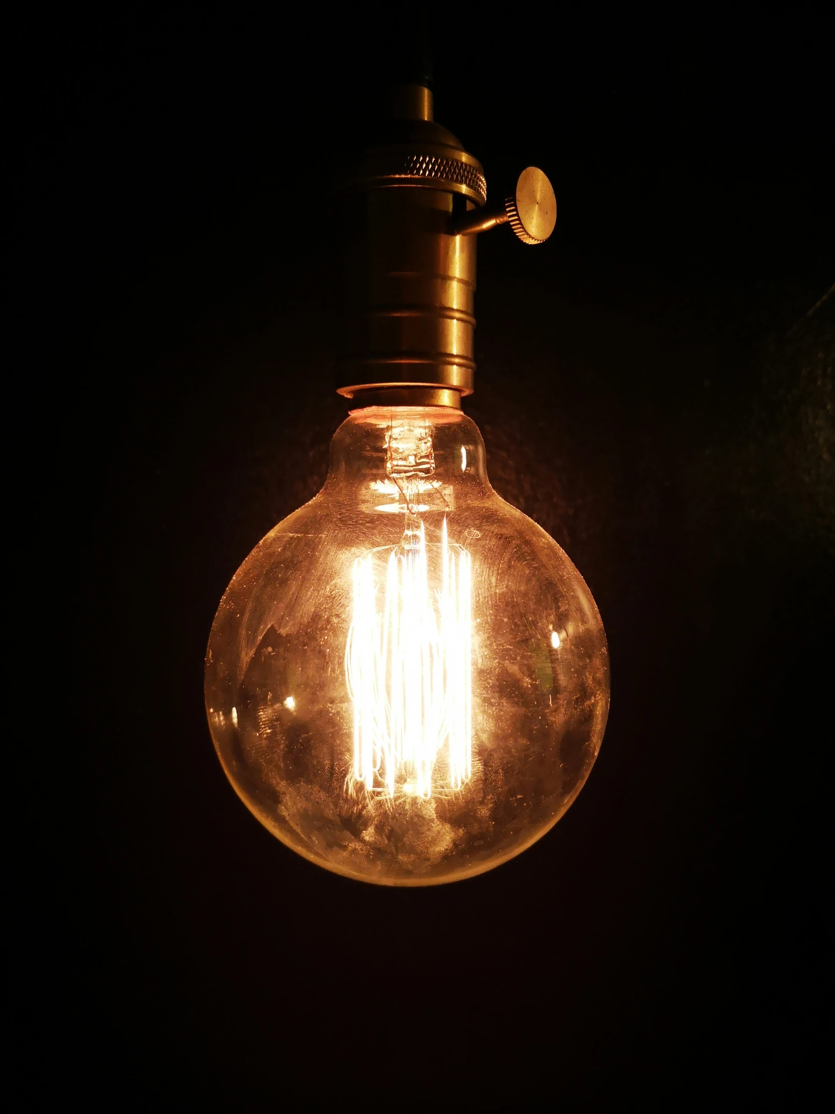 a light bulb hanging from the ceiling in a dark room