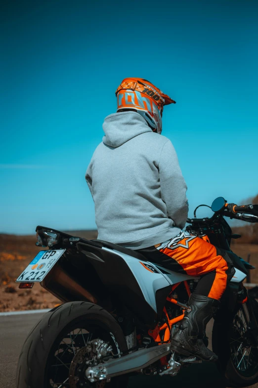 person sitting on motorcycle looking away from camera