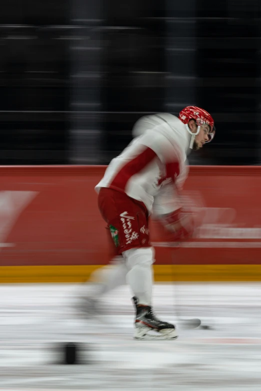 a man skating in a rink at night