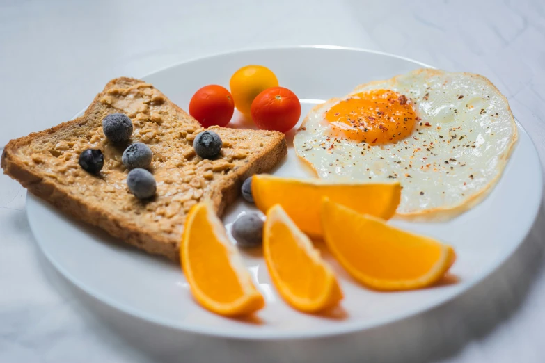 an eggs and bread on a plate with orange slices