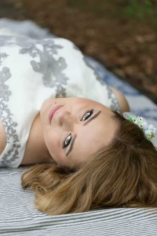 the girl is laying down on the blanket