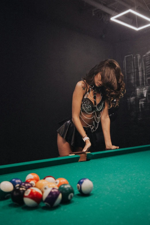 woman in high cut dress leaning down on pool table