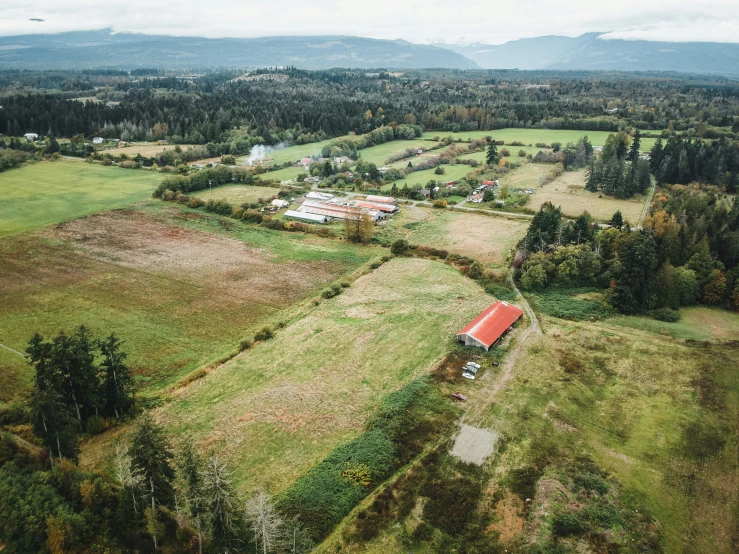 an aerial view of a farm with a small house