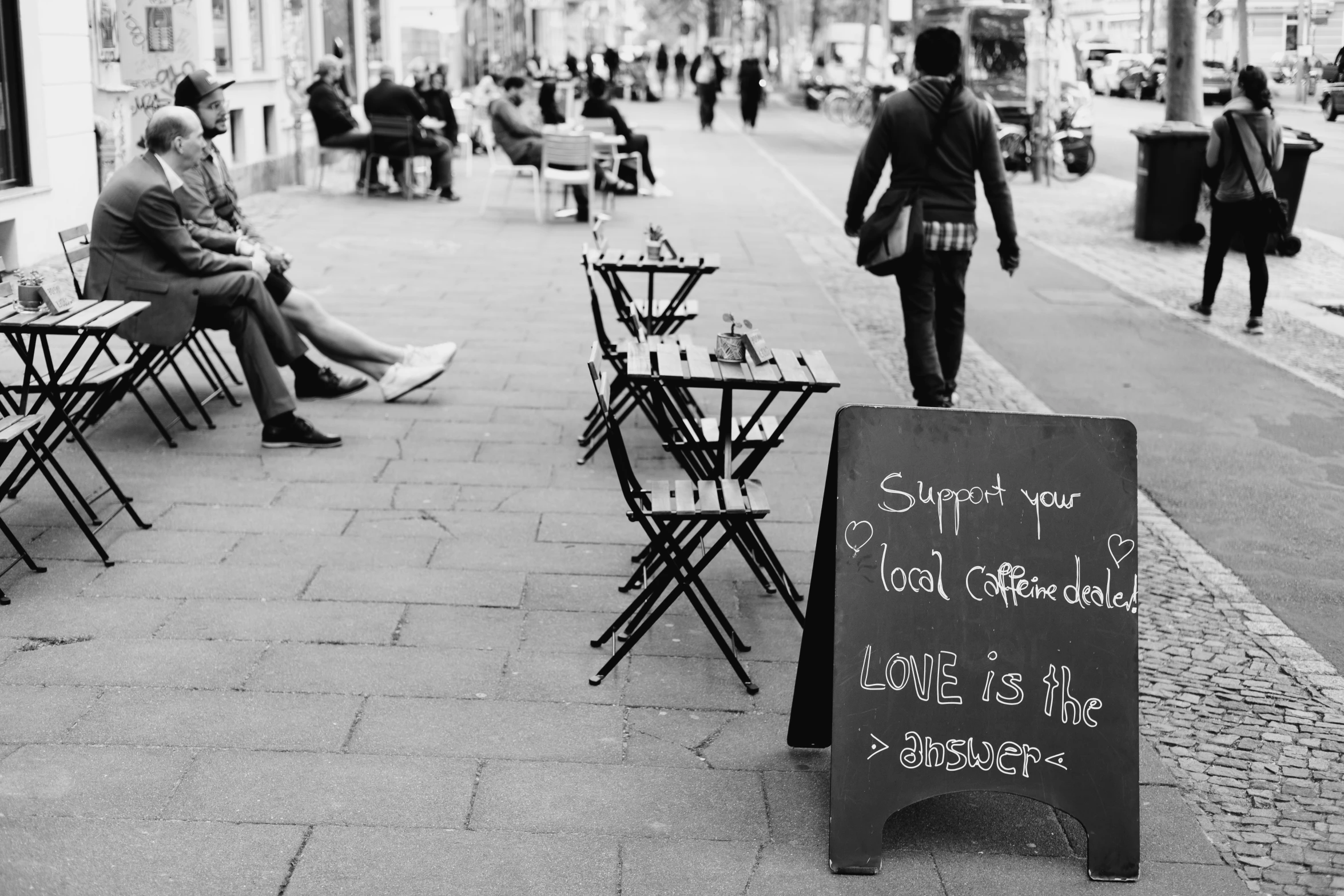 a chalk board is set up on the sidewalk