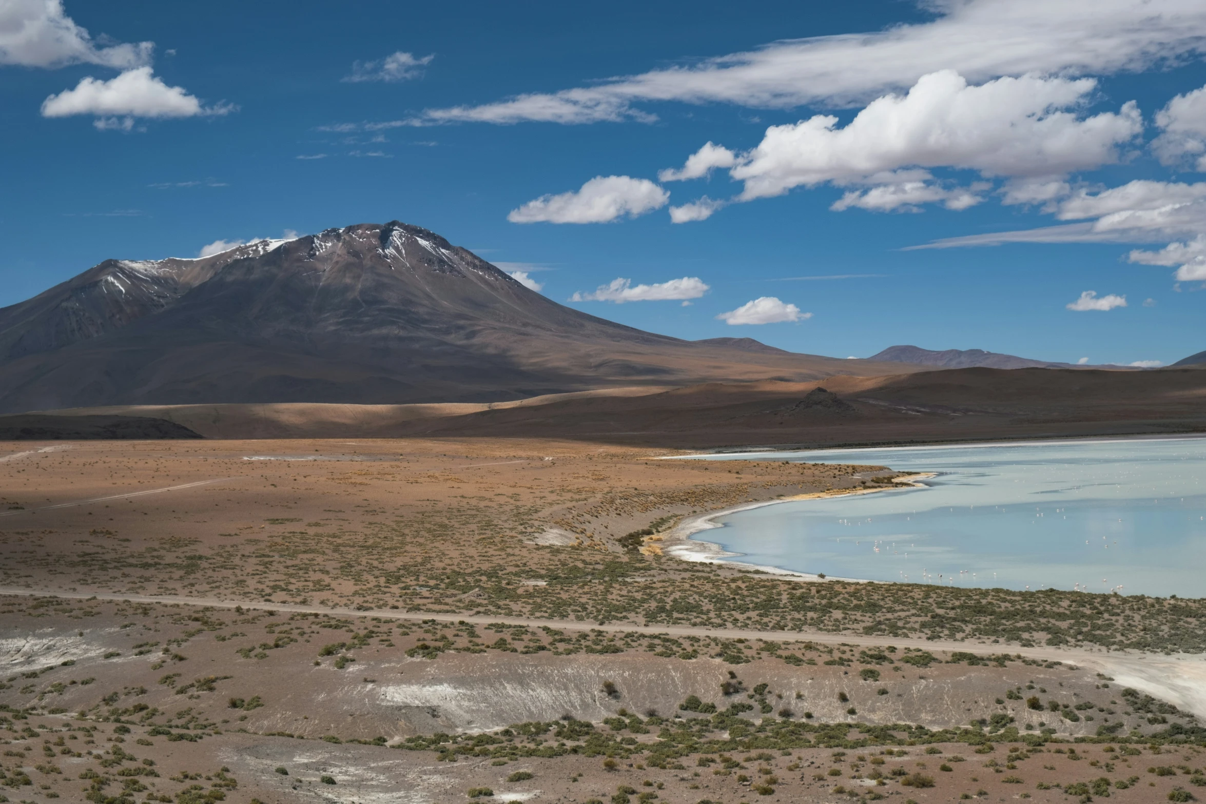 the landscape near mountains has water in it