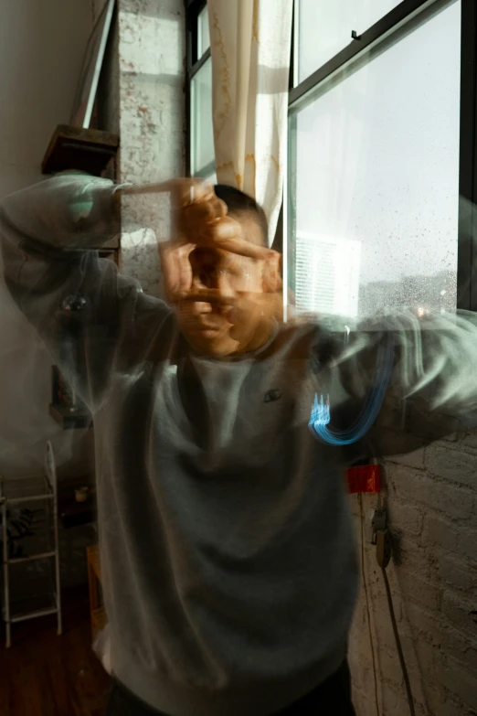 a blurry po of a man in front of a window