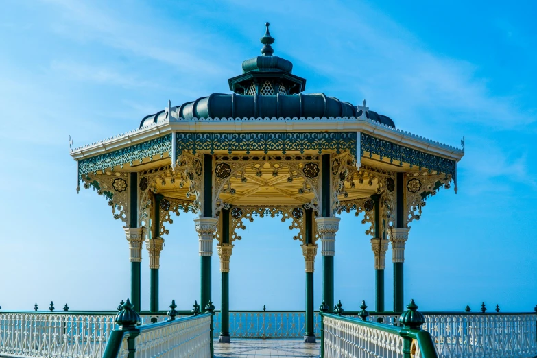 this is a small white, circular structure with wrought iron fences surrounding it