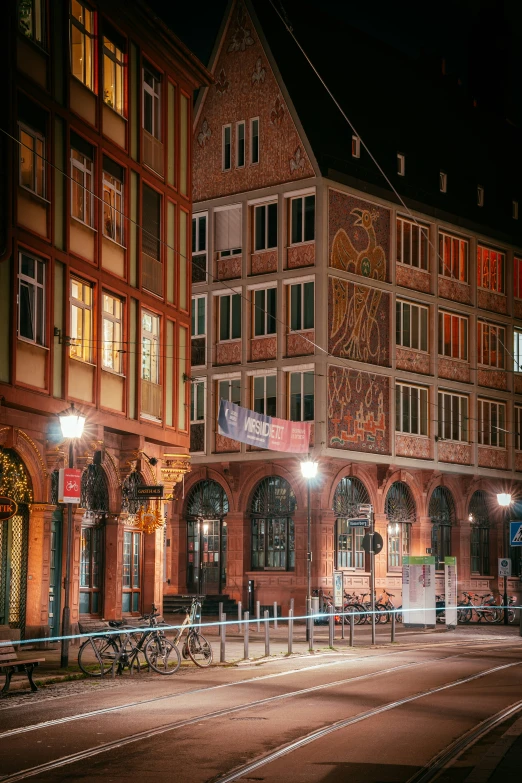 two large buildings lit up at night in the city