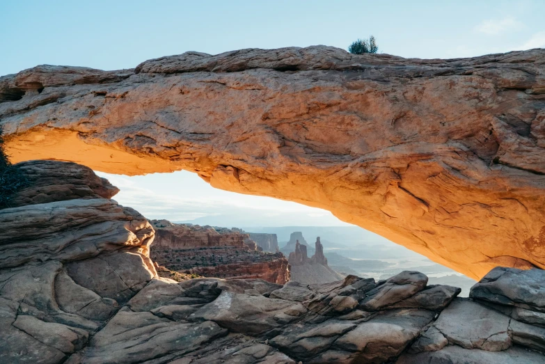 a rock arch with water flowing down it