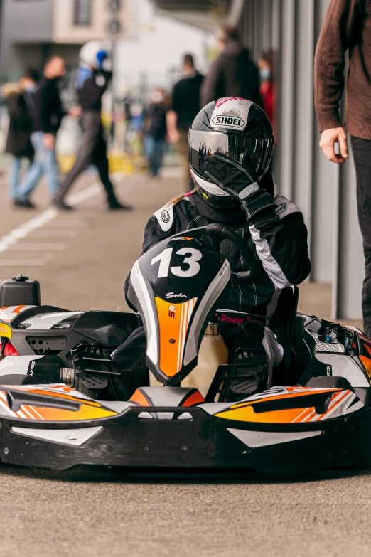 a small child in a go kart wearing a helmet