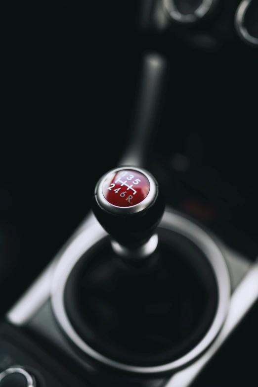 a close up view of a red on on a steering wheel