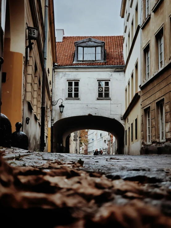 an alley in europe with old buildings and a stone walkway