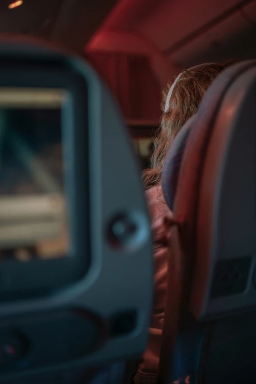 a woman sitting in a seat on an airplane