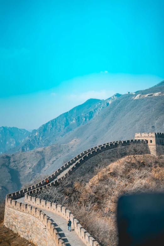 a couple people walking down the side of a mountain