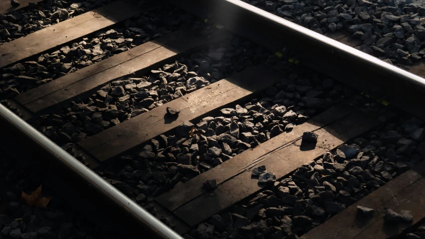 a railroad track with rocks and gravel