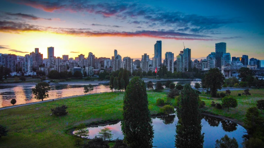 a sunset in the background with a river flowing through it