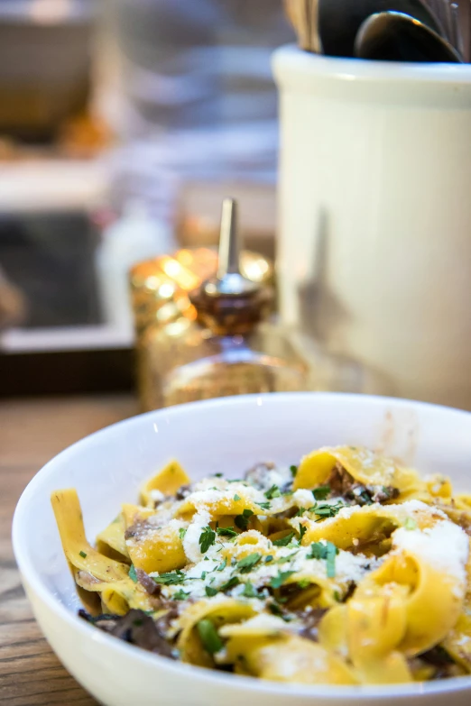 a bowl filled with pasta and topped with cheese